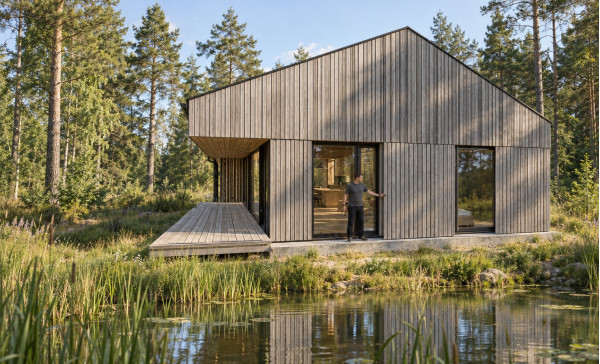 Visualization of the end facade of Gaismas māja with vertical wooden trim, high windows and terrace Visualization of the end facade of Gaismas māja with vertical wooden trim, high windows and terrace