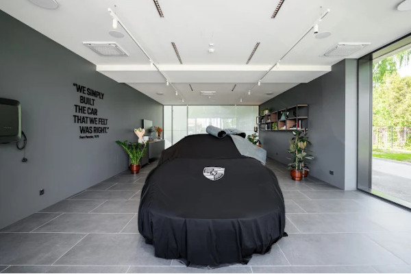 The car presentation room with linear ceiling lights and shelves on the wall.